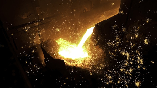 Pouring of liquid metal in open hearth workshop of the metallurgical plant. Stock footage. Smelting of the metal in the foundry at steel mill.